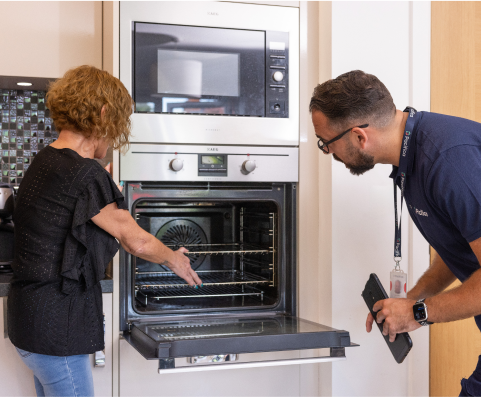 customer showing oven problem to Pacifica engineer for oven repairs