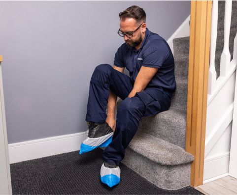 Pacifica engineer putting on protective wear on shoes