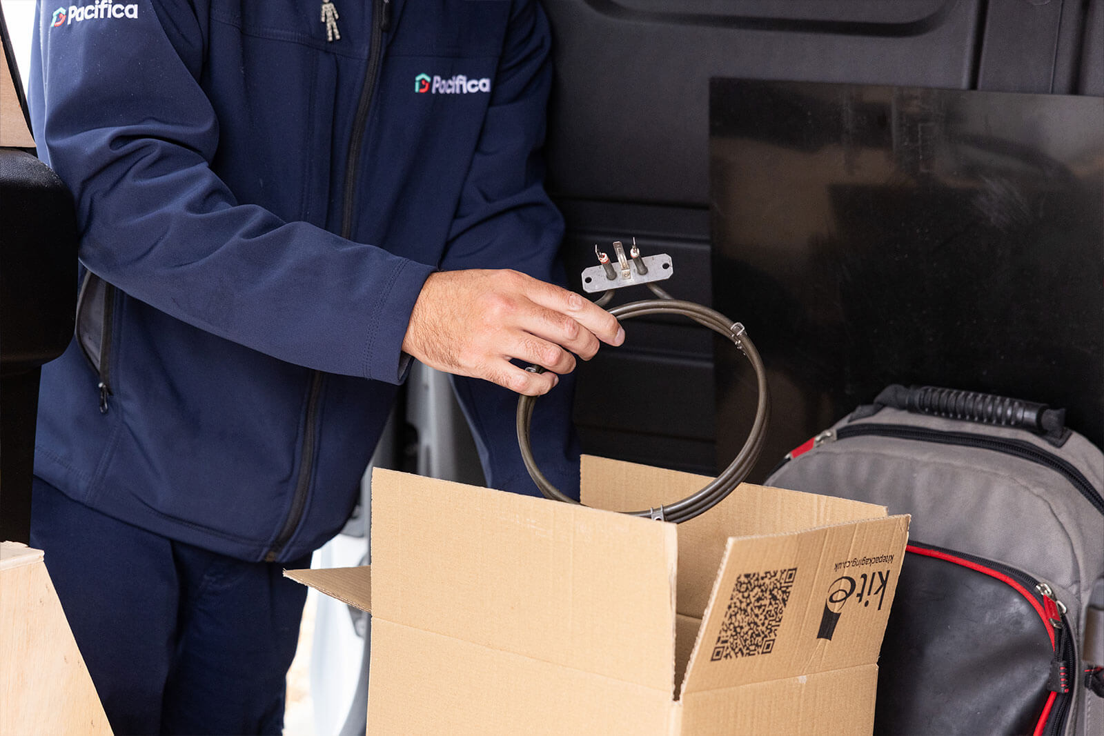 Close-up of Pacifica engineer removing spare parts from box