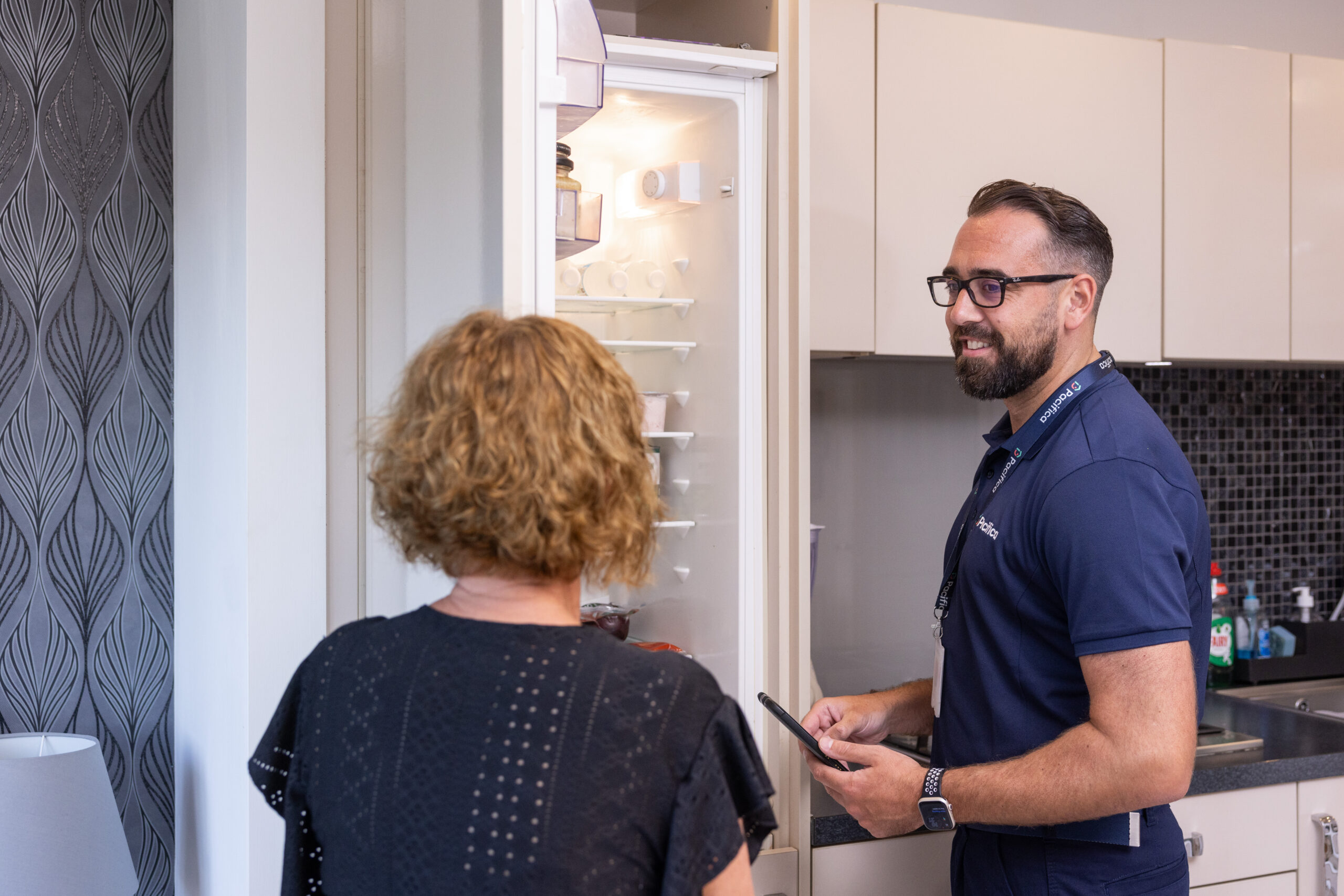 Pacifica engineer speaking with customer during fridge repair service