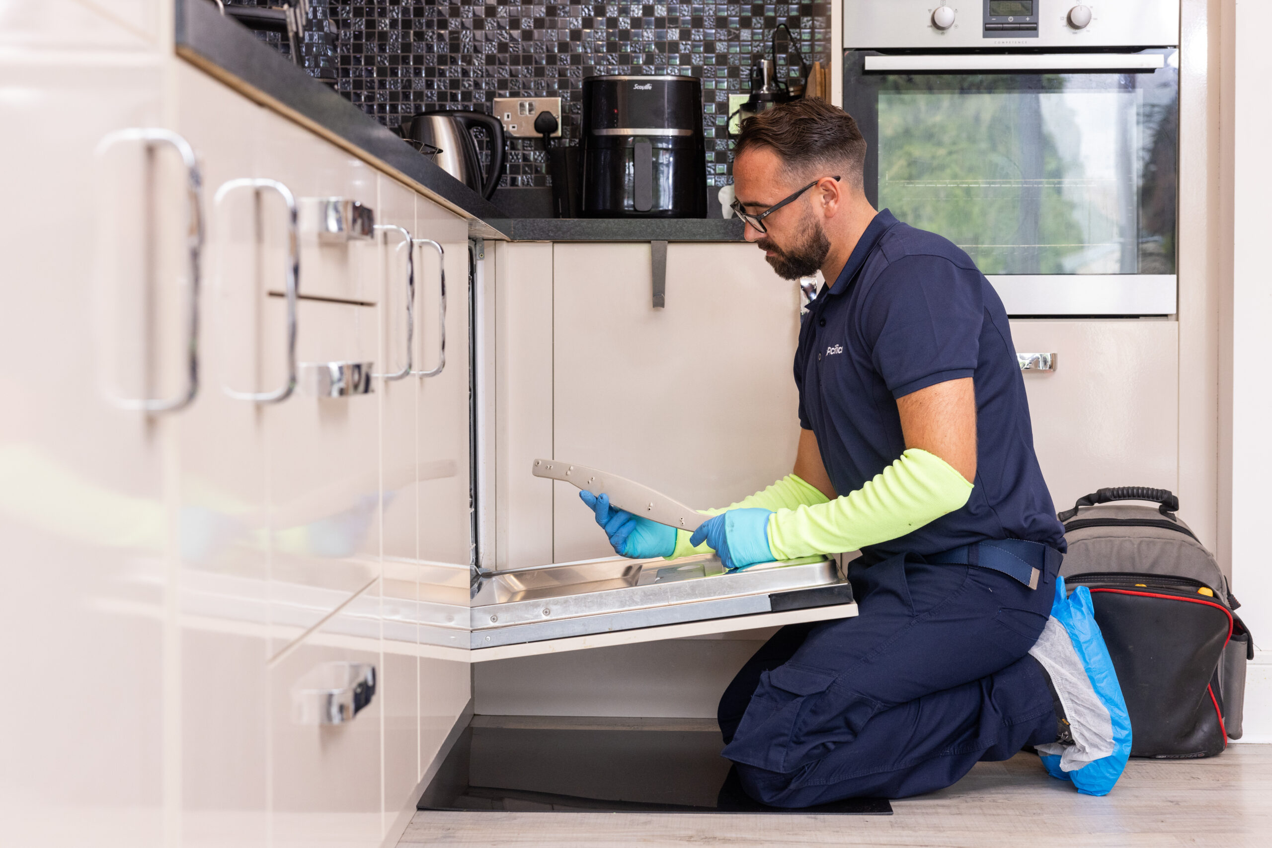 Pacifica engineer performing dishwasher appliance repair