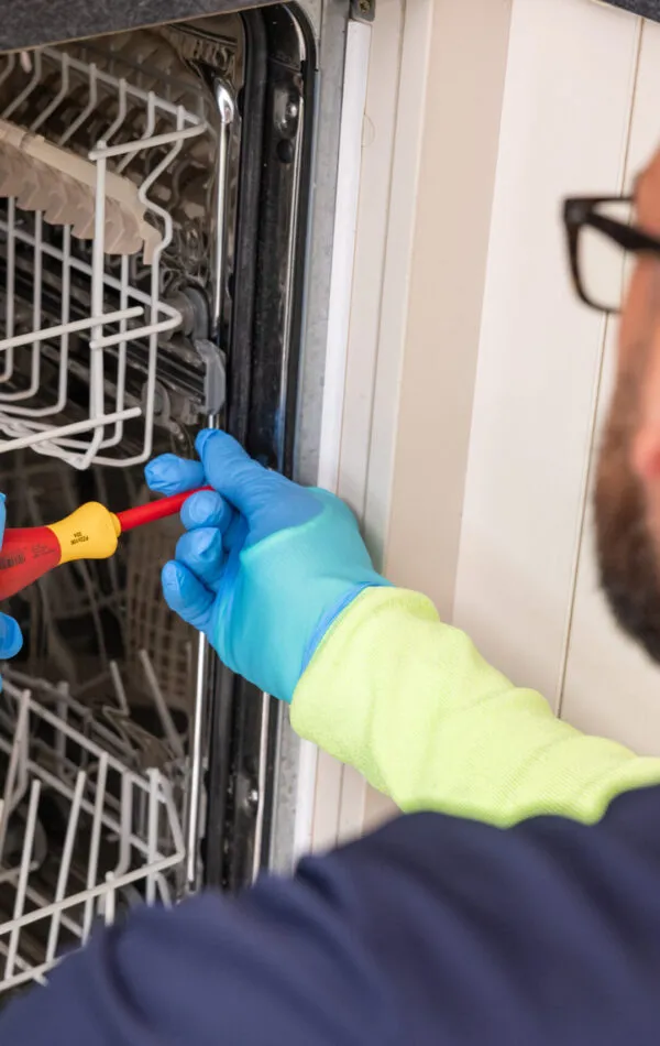 Pacifica engineer fixing dishwasher issue