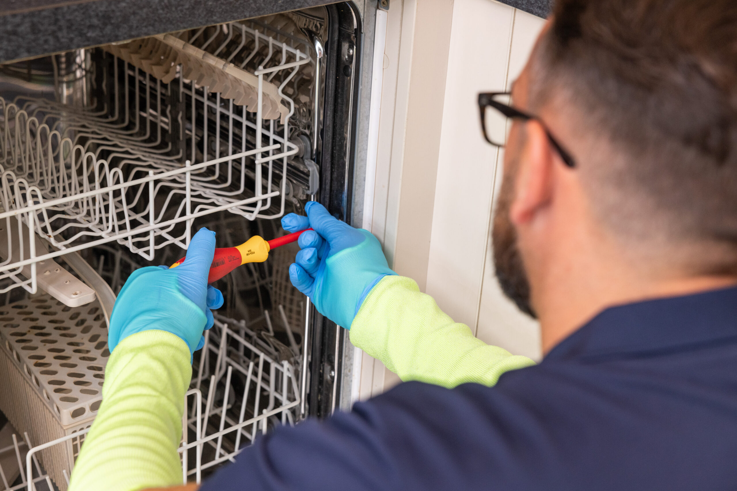 Pacifica engineer fixing dishwasher issue