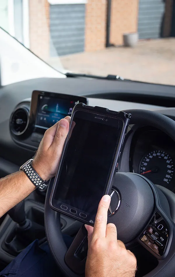 close-up of man looking at ipad in van